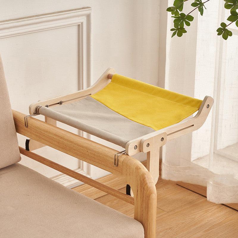 Cozy cat hanging bed with a yellow-gray fabric and sturdy wooden frame, offering a secure and elevated resting space for cats.