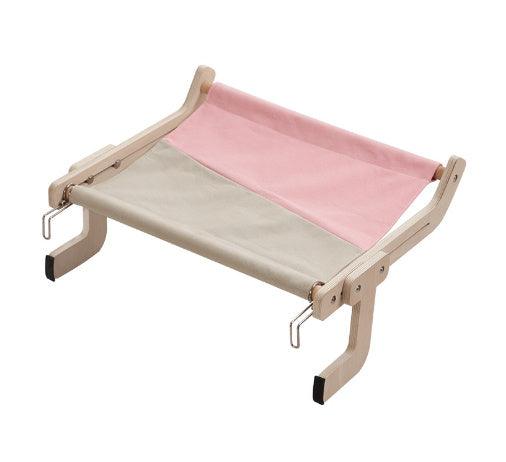 Portable cat hanging bed with a pink-gray fabric and wooden frame, designed for easy installation on furniture or windows.