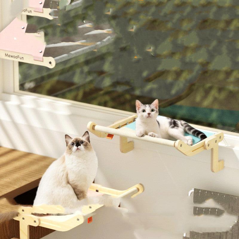 Two cats enjoying their hanging beds with wooden frames and soft fabric, securely mounted on a window for a perfect view.