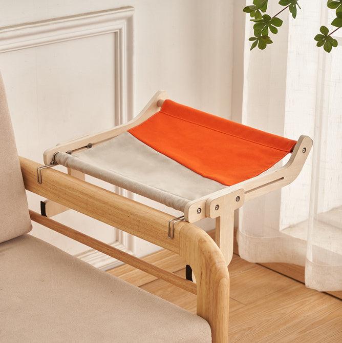 Stylish cat hanging bed with a wooden frame and orange-gray fabric, easily mounted on furniture for a comfortable lounging area.